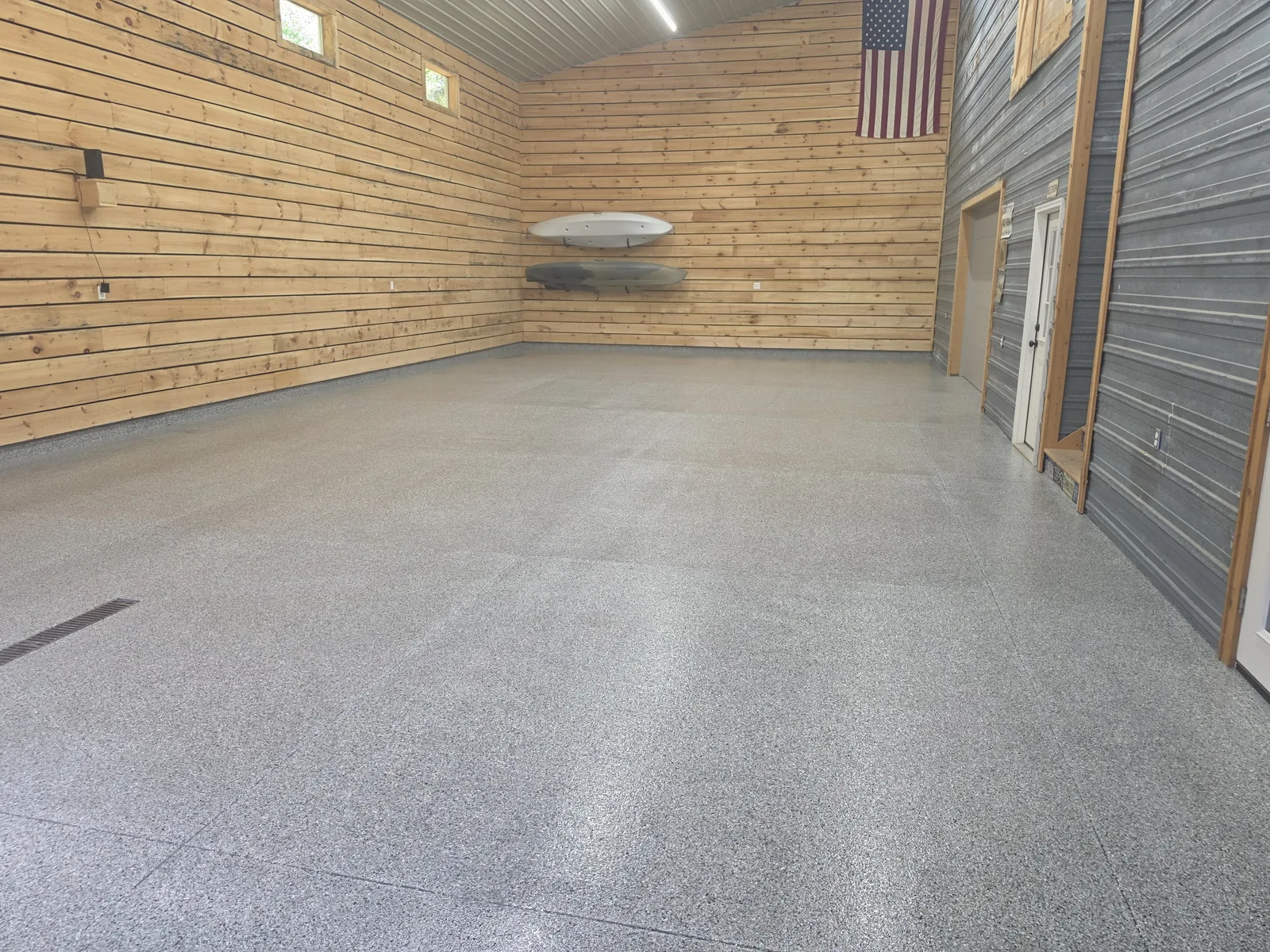Finished full-flake garage floor coating in a large West Michigan shop garage by Armorforge Coatings
