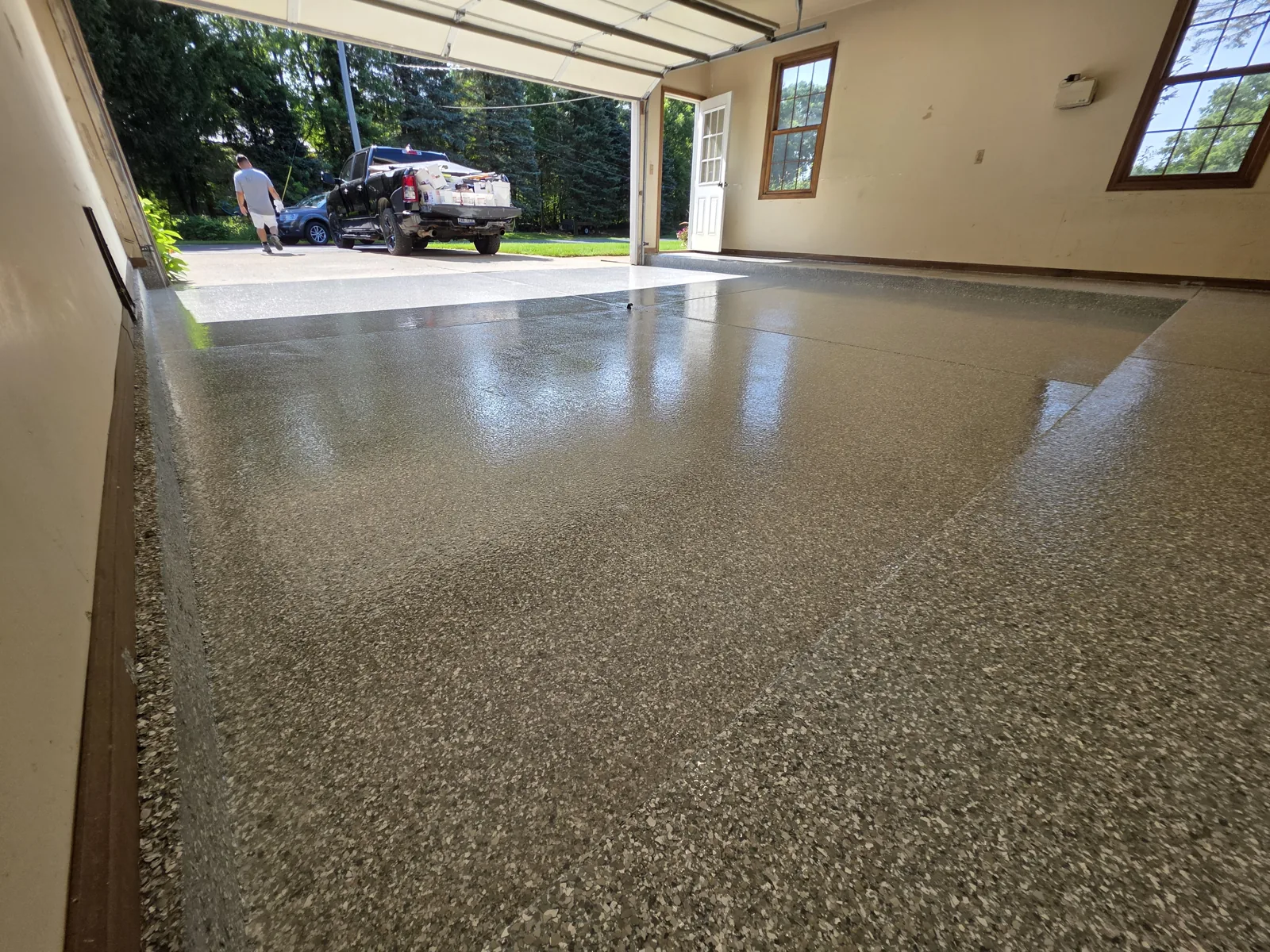 After: finished full-flake polyaspartic garage floor coating in a Grand Rapids, MI two-car garage by Armorforge Coatings