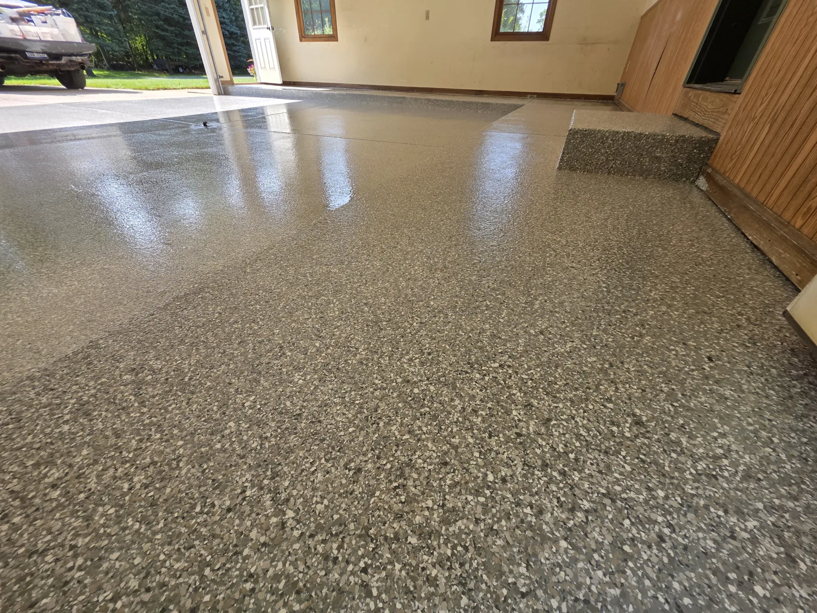 Finished full-flake polyaspartic garage floor in a West Michigan home by Armorforge Coatings