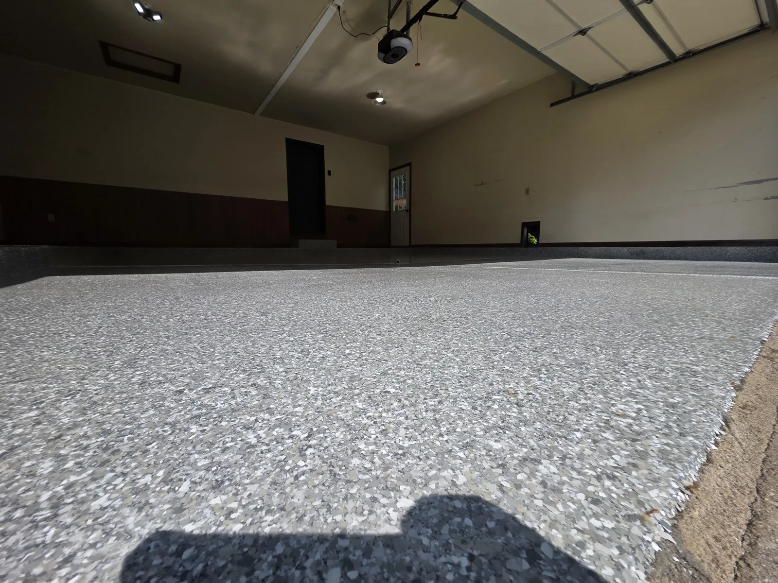 Close-up of the full-flake polyaspartic garage floor coating texture and finish by Armorforge Coatings