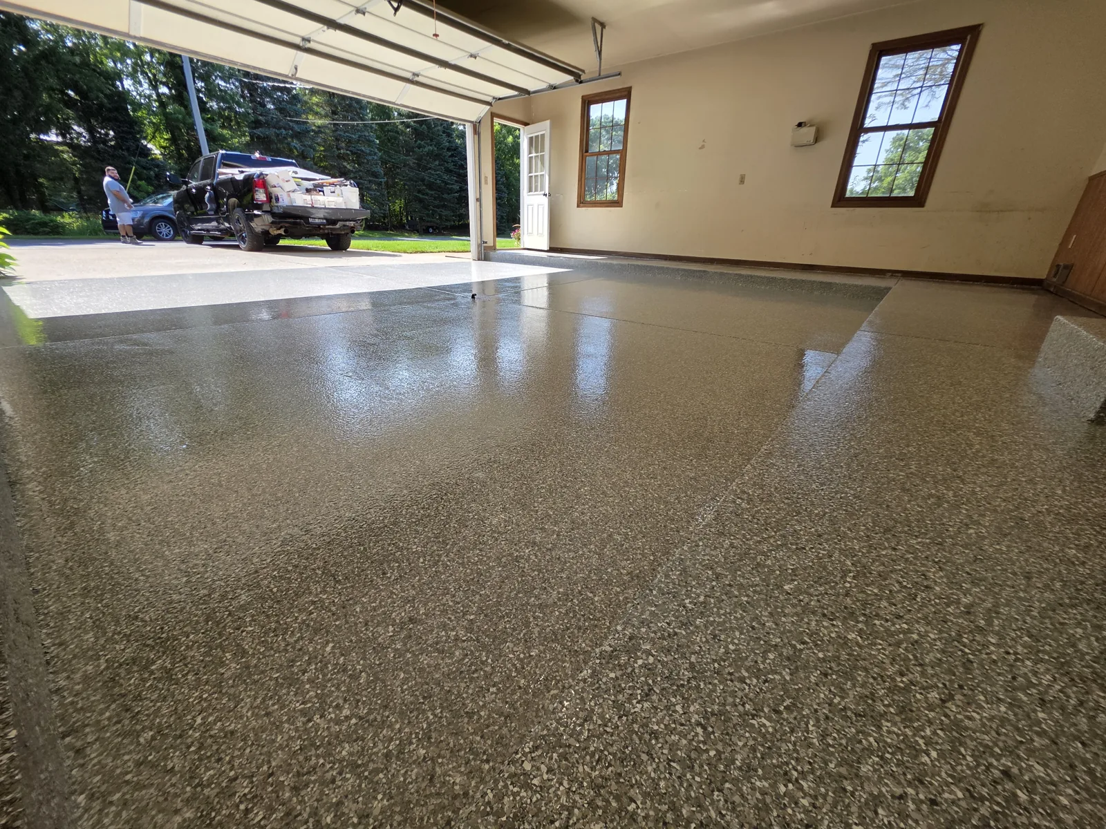 After: finished full-flake polyaspartic garage floor in a Grand Rapids, MI garage by Armorforge Coatings